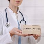 Doctor illustrating balanced hormone health.